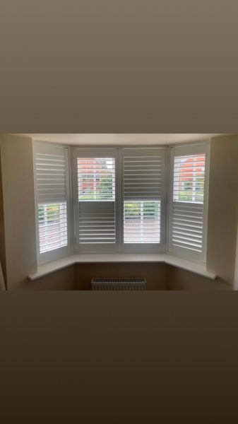 Hardwood shutters in vivid white installed to this three sided bay window: Swipe To View More Images