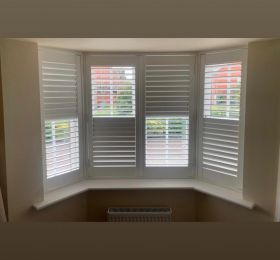 Hardwood shutters in vivid white installed to this three sided bay window: Click Here To View Larger Image